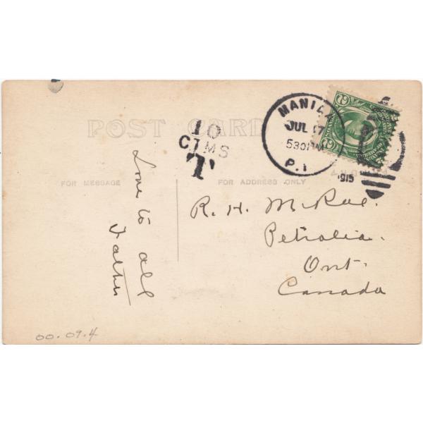 Back of a postcard with a handwritten note. There is a green postage stamp and a postmark from Manila in the top right corner. 