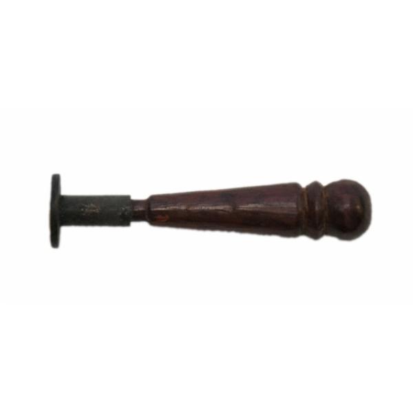 Side view of a small letter seal showing the wooden handle. It has a round head and tapers towards the metal seal. 