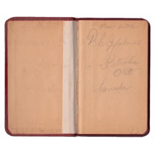 Inside front of a record book. The pages are yellow and the cover reads "D.C. Holmes, Petrolia Ont Canada." 