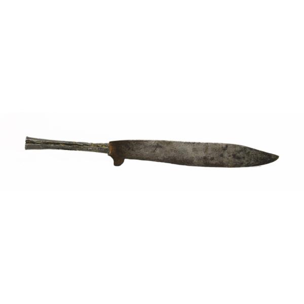 A metal knife with a plain handle, facing right. There is a fin coming off of the bottom of the blade near the handle.