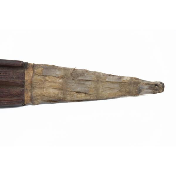 The tip of the sheath, made of a light material like parchment.