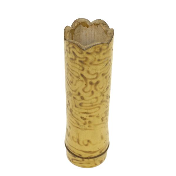 The top-view of one of the vases. The vase is yellow in colour and has a swirl pattern burned into the bamboo. 