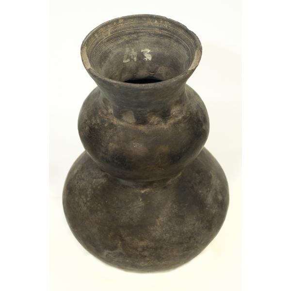 Top view of a mottled-black creamware jug with waist, showing the flared neck with fingerprints at the base of that section. 