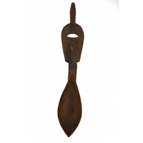 A carved wooden spoon decorated with hatching and dots on the handle. There is a hole carved into the handle, as well. 