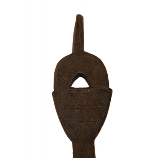 A close-up view of a carved wooden spoon handle which has a stem and a hole in the centre. It is decorated with diagonal hatching. 