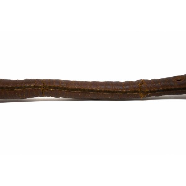 The shaft of a club covered in cracked brown leather. There is a seam running horizontally along the middle that has been stitched with light-coloured thread. 