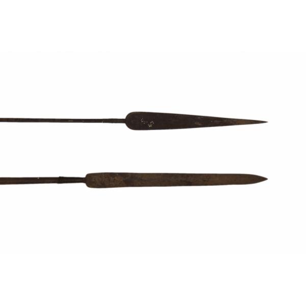 Two metal spearheads. The one on the top is rounded and tapers to a point. The one of the bottom is straight and tapers at the end to a point.