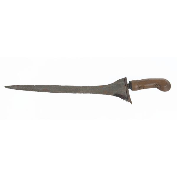 A metal knife with a wooden handle pointing left. There are carvings on the underside of the handle.  