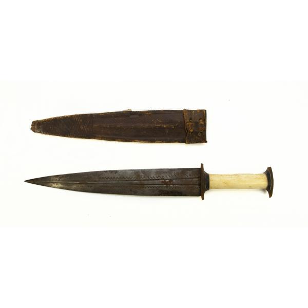 A metal dagger with an ivory handle and a leather sheath pointing to the left. The blade is symmetrical and there are two grooves running the length of the blade. There is a "v" pattern towards the edge of the blade. There are decorative diagonal lines running vertically on the sheath. 