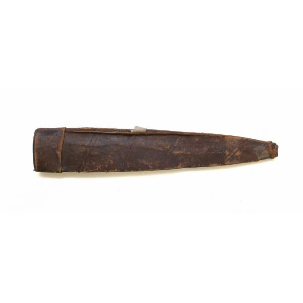 A leather sheath from a dagger pointing right. The tip is decorated with crosshatching and the body has a series of lines that form an "X". There are four holes at the opening end with pieces of leather string in them. 