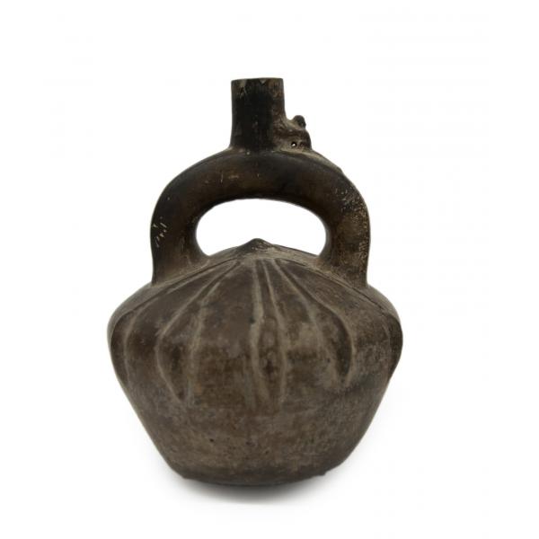 Front side of dark brown stirrup-spout bottle. Decorated with a low-relief, radiating pattern.