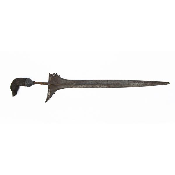 A dagger blade pointing right. It has a metal blade that is asymmetrical at the hilt and a carved wooden handle in the shape of a bird. 