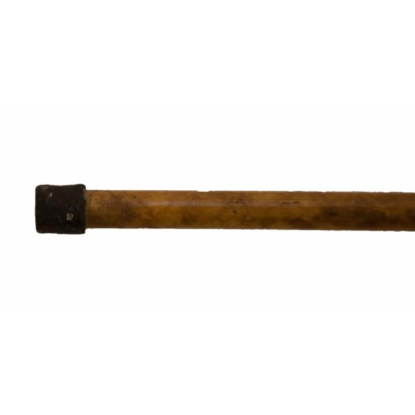 The metal base of a bamboo walking cane. It is flat on the bottom. 