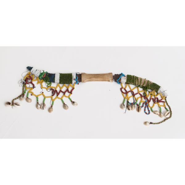 Two curved metal blades held together in the centre by an ivory handle. Each blade is covered with leather, dark blue cloth, and rows of coloured beads and shells. 