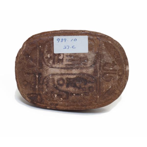 The bottom of the brown ceramic scarab which is inscribed with two names of Ramses. 