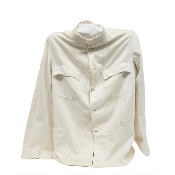 The front of a white jacket. It has a pocket on either breast with a flap to close them and an open pocket on either side near the waist. There are five white buttons running down the middle of the shirt.