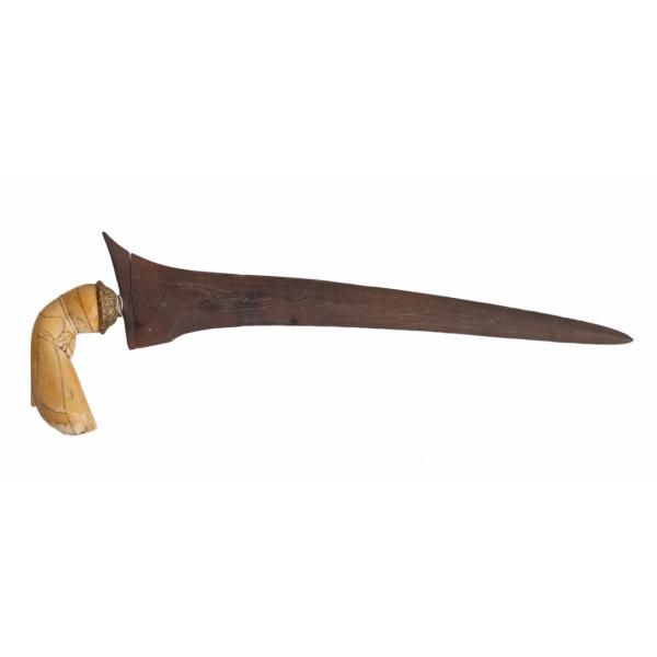 A metal dagger with an ivory handle, pointing to the right. The blade is curved and rusted, and there is a swirling pattern in the metal. 