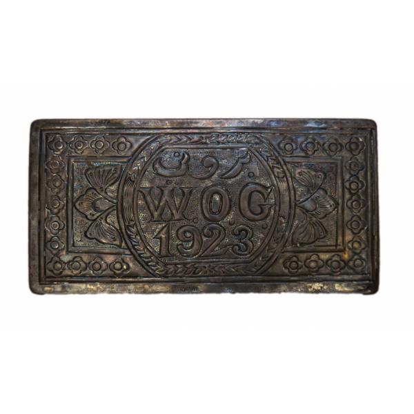 Top view of William Gillespie's metal cigarette case carved with his initials and the year 1923.