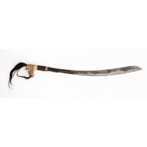 A metal axe with a curved blade and an ivory-coloured handle. The handle is carved into a dragon's head with black tufts of hair. There is a rattan braid wrapped around the base.