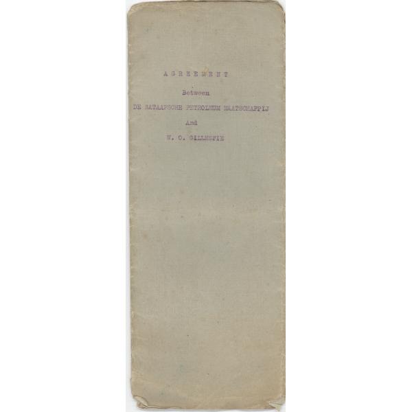 The cover of a contract. It is long and slender. The paper is grey with, "Agreement Between DE BATAASCHE PETROLEUM MAATSCHAPPIJ And W. O. Gillespie" typewritten on it with purple ink.