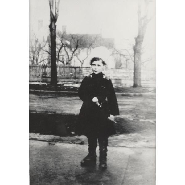 Charles Wallen Jr. standing in his Cossack uniform, including white hat, coat, boots, and sword.