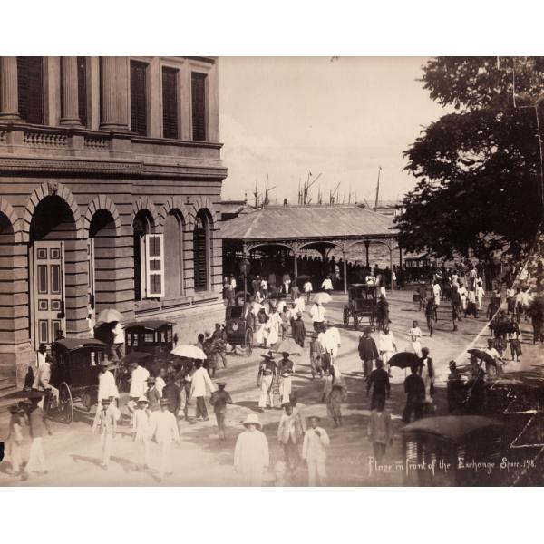 Photo d'une rue bondée à l'extérieur d'un grand bâtiment près du bord de l'eau. 