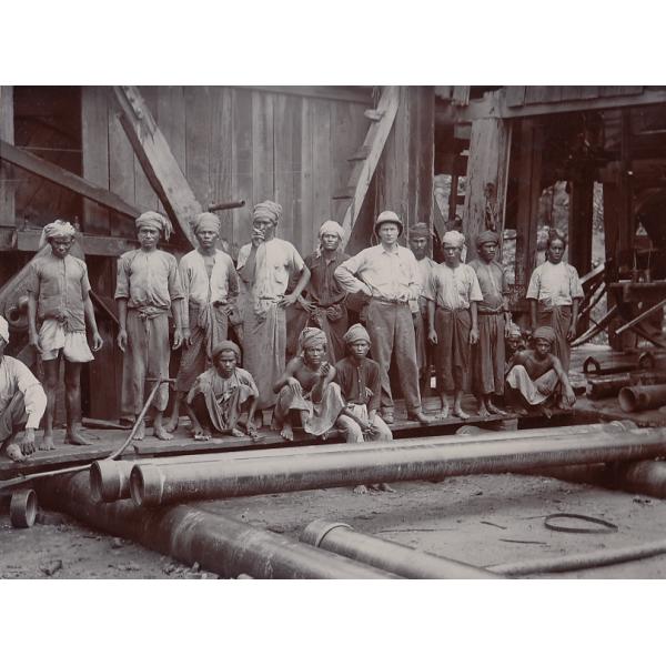 Joe O'Donnell and his crew posed in front of an oil rig. 