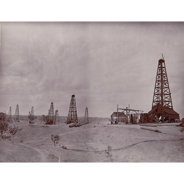 Oil field with a few rigs in the background.