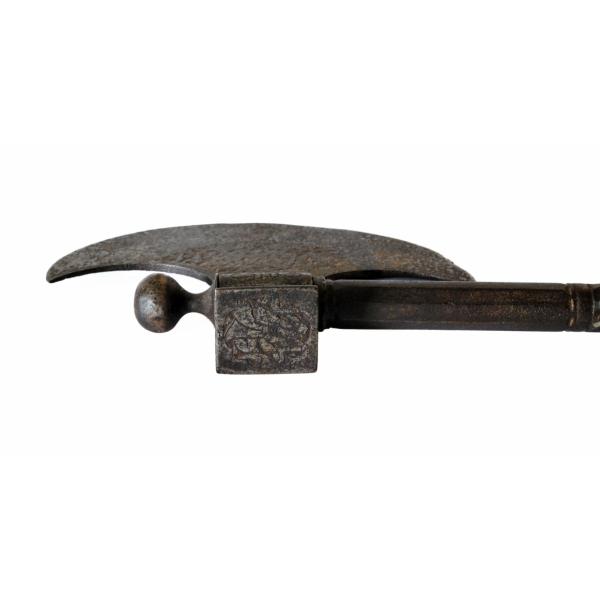 The head of a Persian saddle-axe. It is used for deflecting. It is square and sticks off of the back of the blade on the opposite side of the handle.