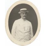 Oval portrait shot of William McRae in a white suit and panama hat. 