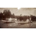 Three International Drillers, two in one canoe and one in another. There is a local man each canoe, as well. A third canoe is in the background.  