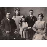 A family portrait with Fred Webb seating on the far left with his wife on the right and three children in the center.