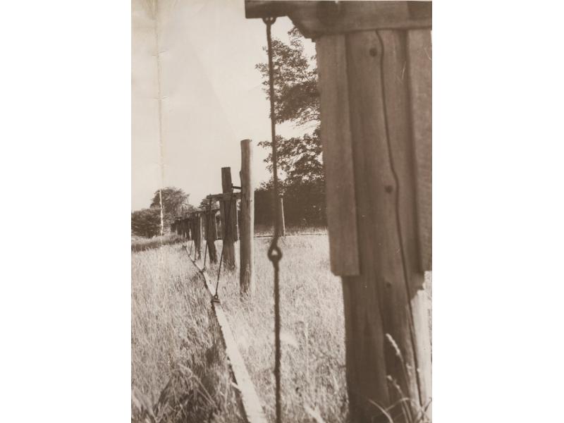 Close-up of wire hangers holding the ash poles of the jerker lines.