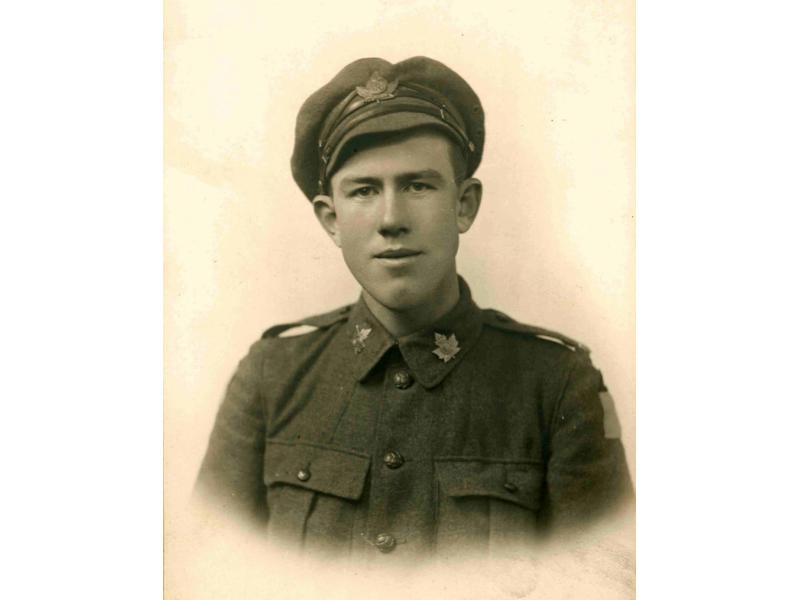 A photo of Alfred Harper from the chest up. He is wearing a military uniform with maple leaf insignia on the collar of his jacket and on his hat.