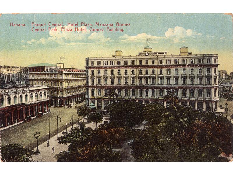 A postcard showing three large buildings with many windows. They are around a square with trees in it. The sky is blue with clouds. The card reads: "Habana. Parque Central, Hotel Plaza, Manzana Gomez. Central Park, Plaza Hotel, Gomez Building."