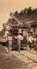 Four men standing in front of a rail car. 