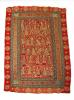 A red and gold embroidered throw rug. There are six rows of figures surrounded by four rows of patterned borders. 
