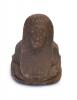  The front of a brown ceramic, human-headed scarab. Eyes, ears, a nose, and a mouth have been etched into the figure's head along with a headdress. 