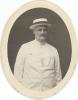 Oval portrait shot of William McRae in a white suit and panama hat. 