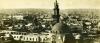 A photo of the city of Cairo taken from a rooftop. There is a domed building in the foreground and a tower just behind it.