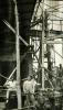 An International Driller and two local workers standing underneath an oil rig.